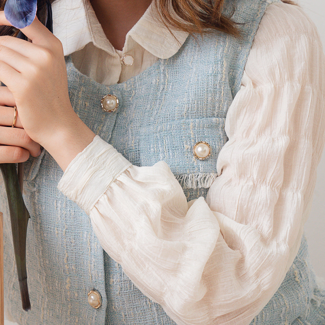 Cora Tweed Top displayed on a mannequin, showcasing its elegant design and fabric texture.