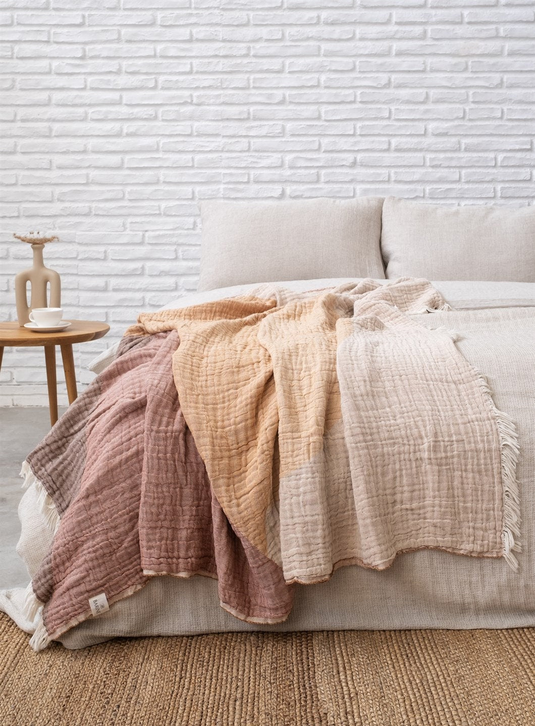 A cozy Cotton Boho Throw Blanket displayed on a couch, showcasing its soft texture and stylish design.