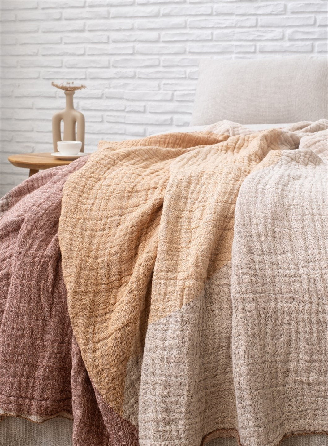 A cozy Cotton Boho Throw Blanket displayed on a couch, showcasing its soft texture and stylish design.