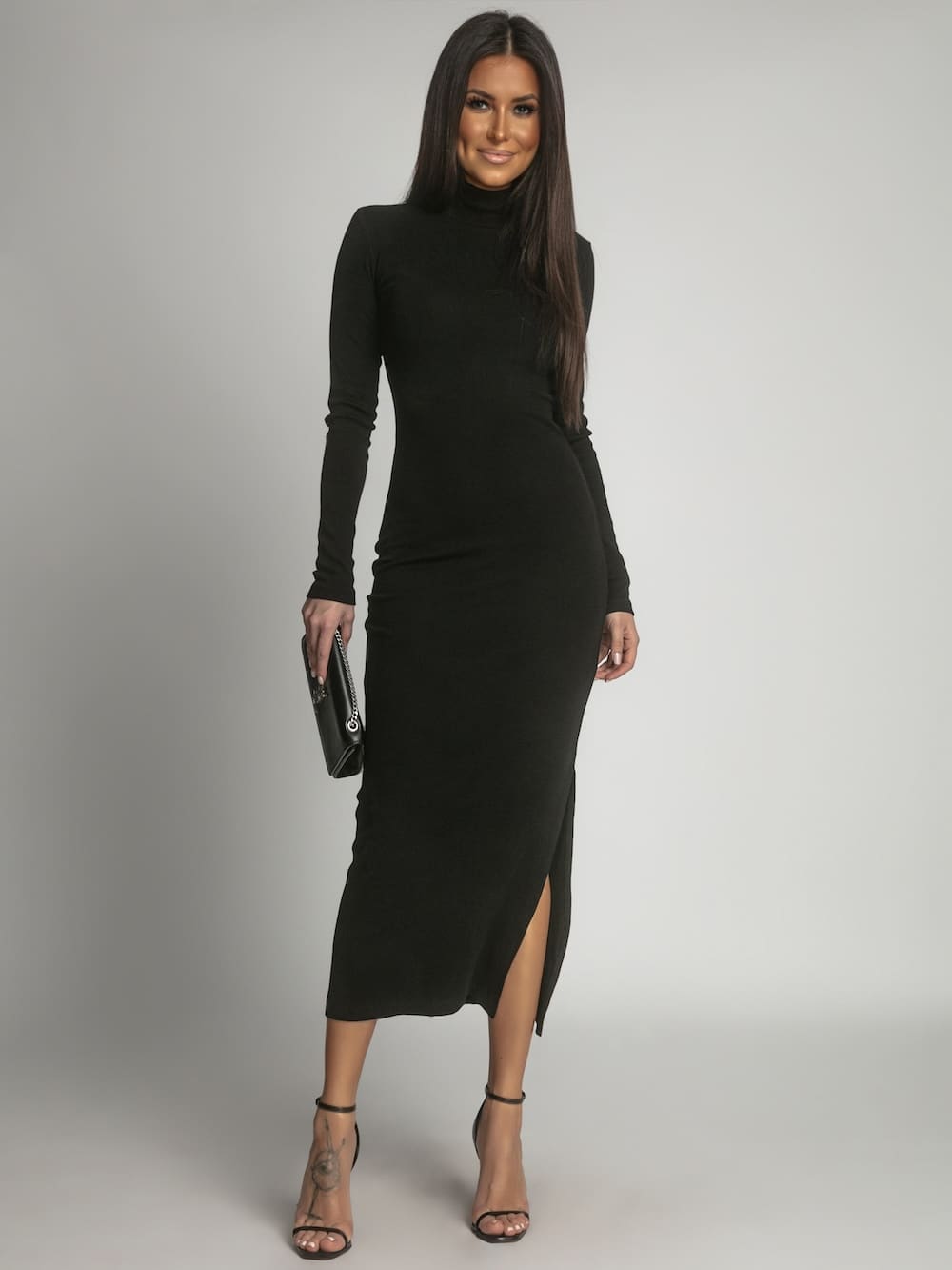 A stylish black cotton fitted maxi dress with a turtleneck, showcasing its elegant design and soft fabric, perfect for various occasions.