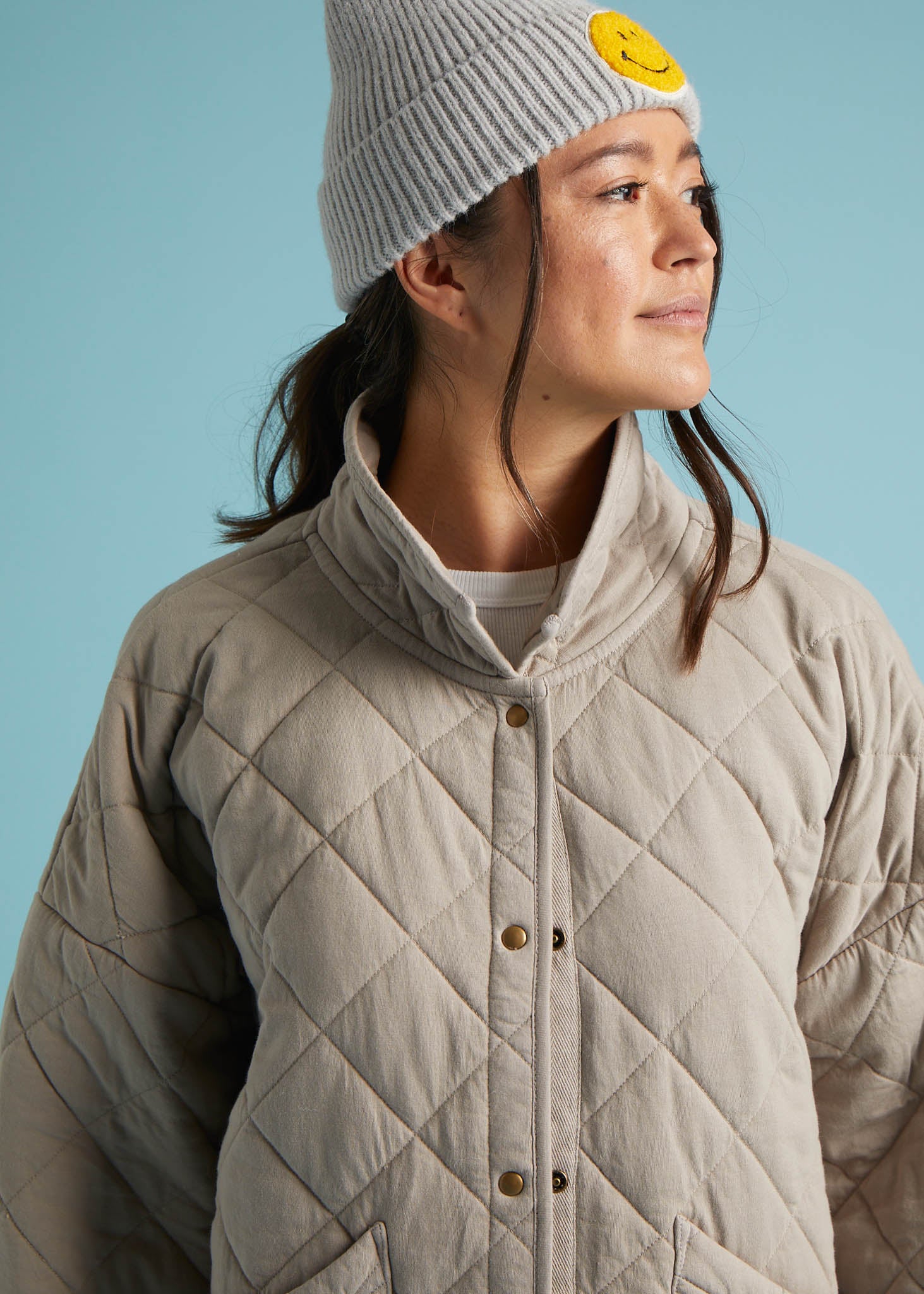 A stylish Countryside Quilted Jacket in Pebble color, featuring quilted stitching, front slip pockets, and a relaxed design, perfect for layering.