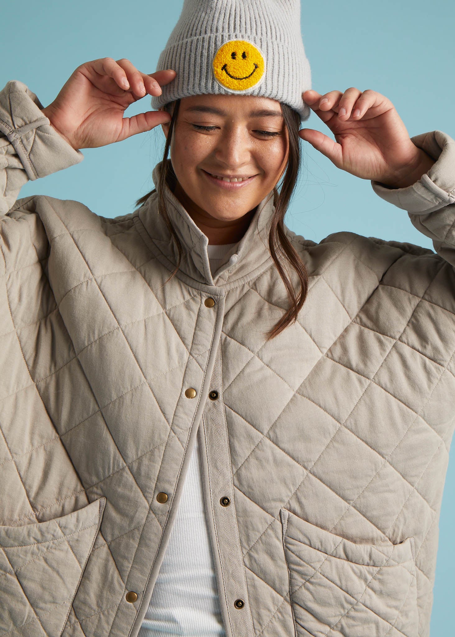 A stylish Countryside Quilted Jacket in Pebble color, featuring quilted stitching, front slip pockets, and a relaxed design, perfect for layering.