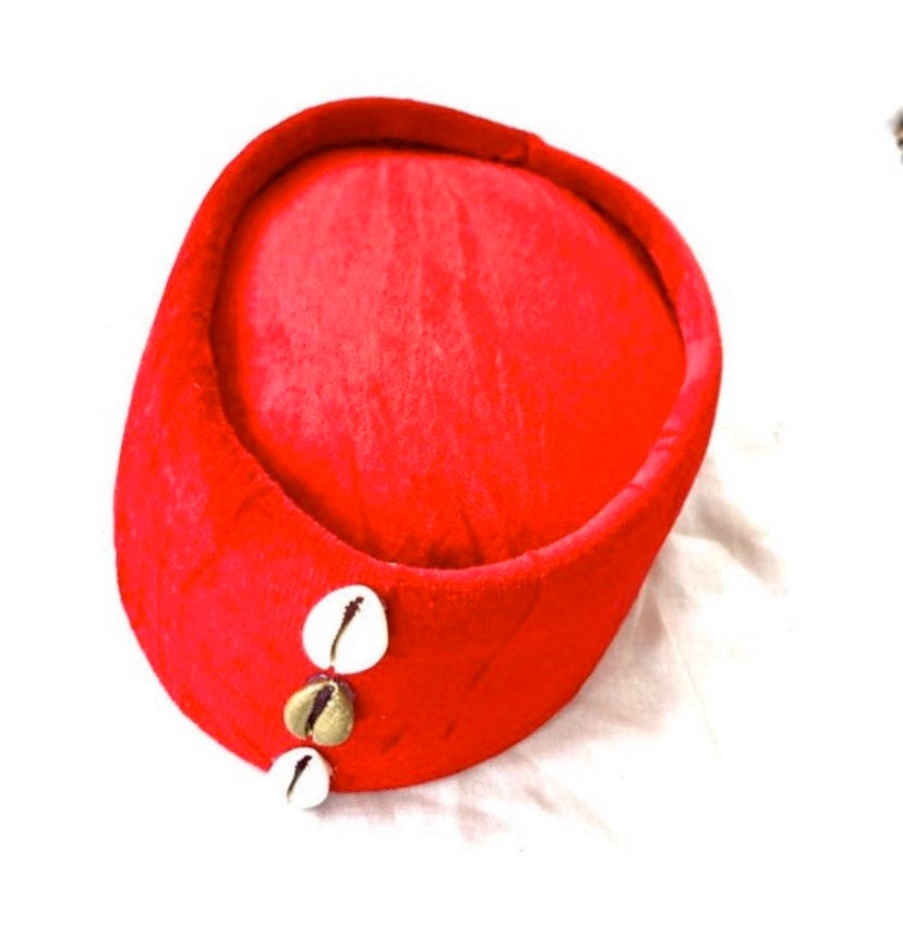 A vibrant red Cowries African hat adorned with decorative cowrie shells, showcasing its unique design and craftsmanship.