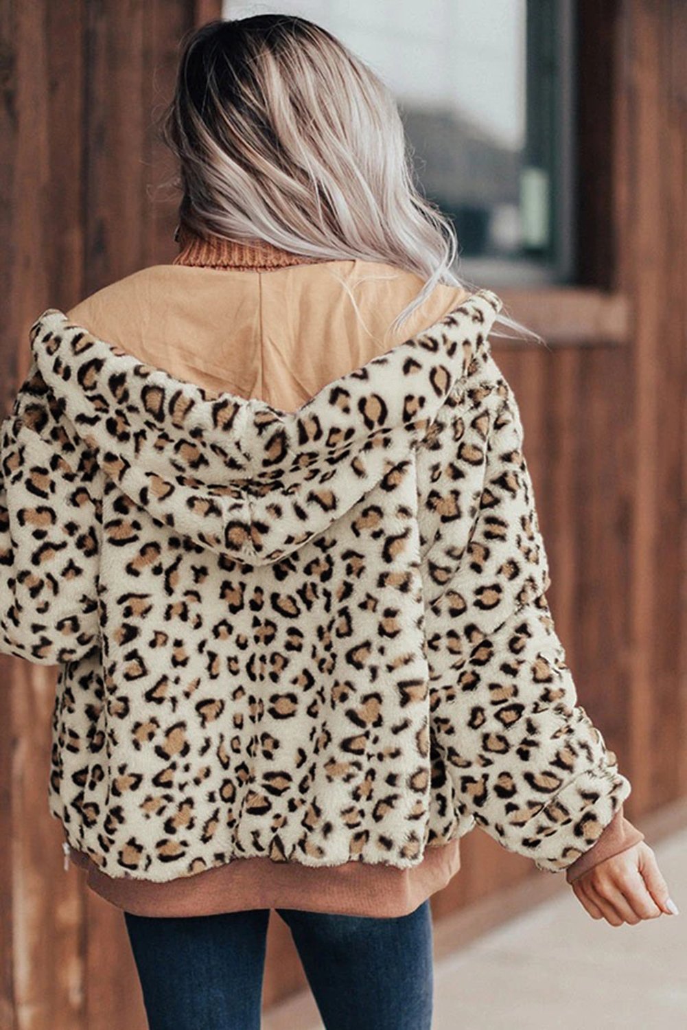 Cozy Plush Leopard Jacket featuring ultra-soft faux fur, bold leopard print, and a hooded back with hidden side pockets.