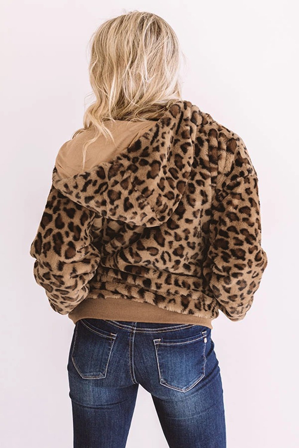 Cozy Plush Leopard Jacket featuring ultra-soft faux fur, bold leopard print, and a hooded back with hidden side pockets.