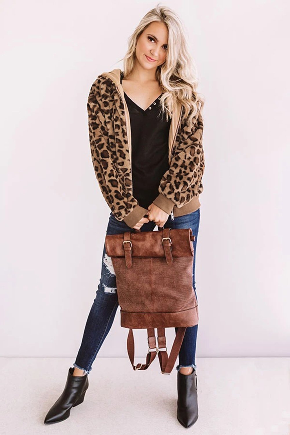 Cozy Plush Leopard Jacket featuring ultra-soft faux fur, bold leopard print, and a hooded back with hidden side pockets.