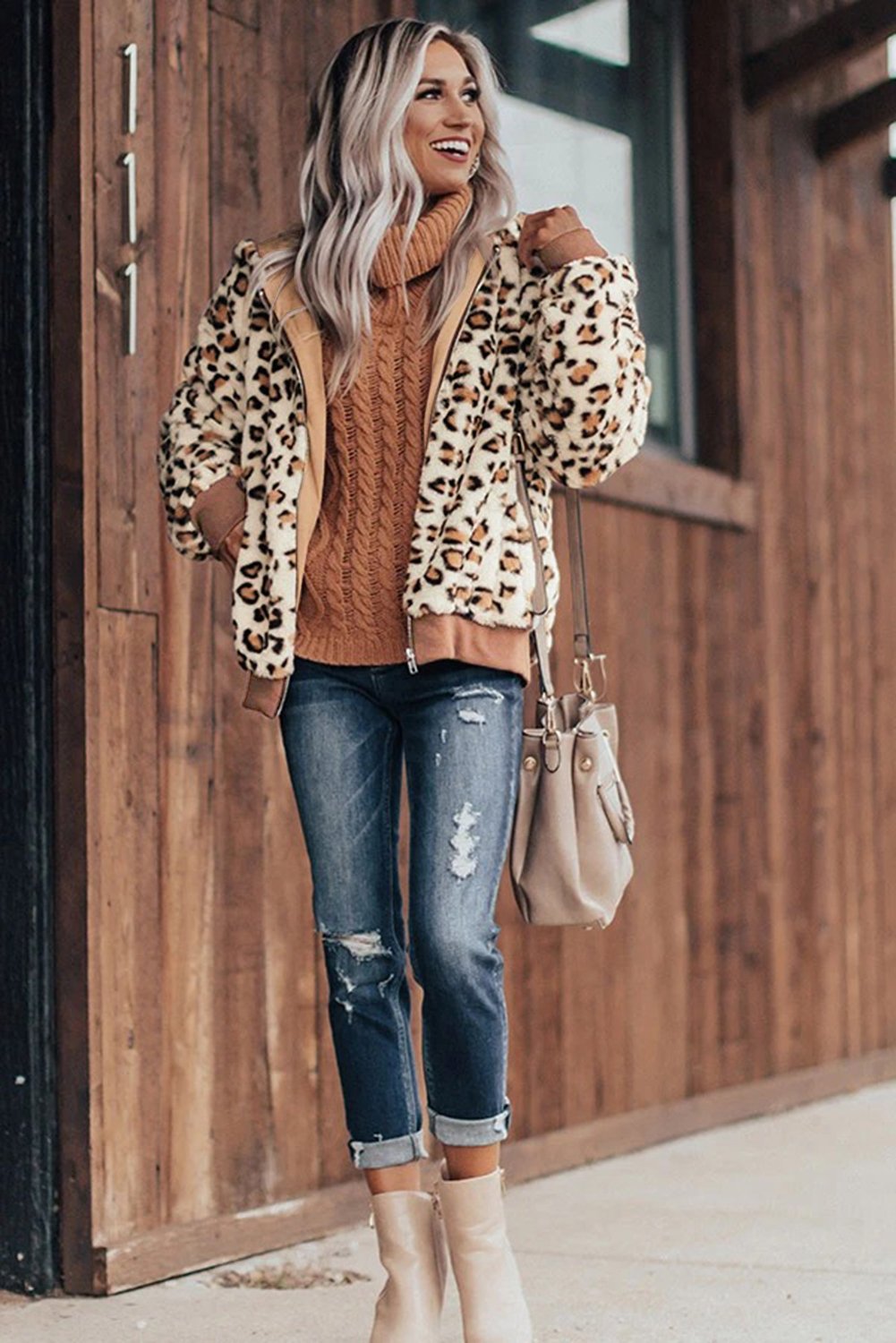 Cozy Plush Leopard Jacket featuring ultra-soft faux fur, bold leopard print, and a hooded back with hidden side pockets.