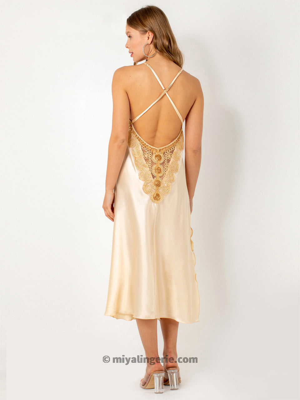 Elegant cream long satin negligee gown draped gracefully, showcasing its luxurious fabric and flattering design.