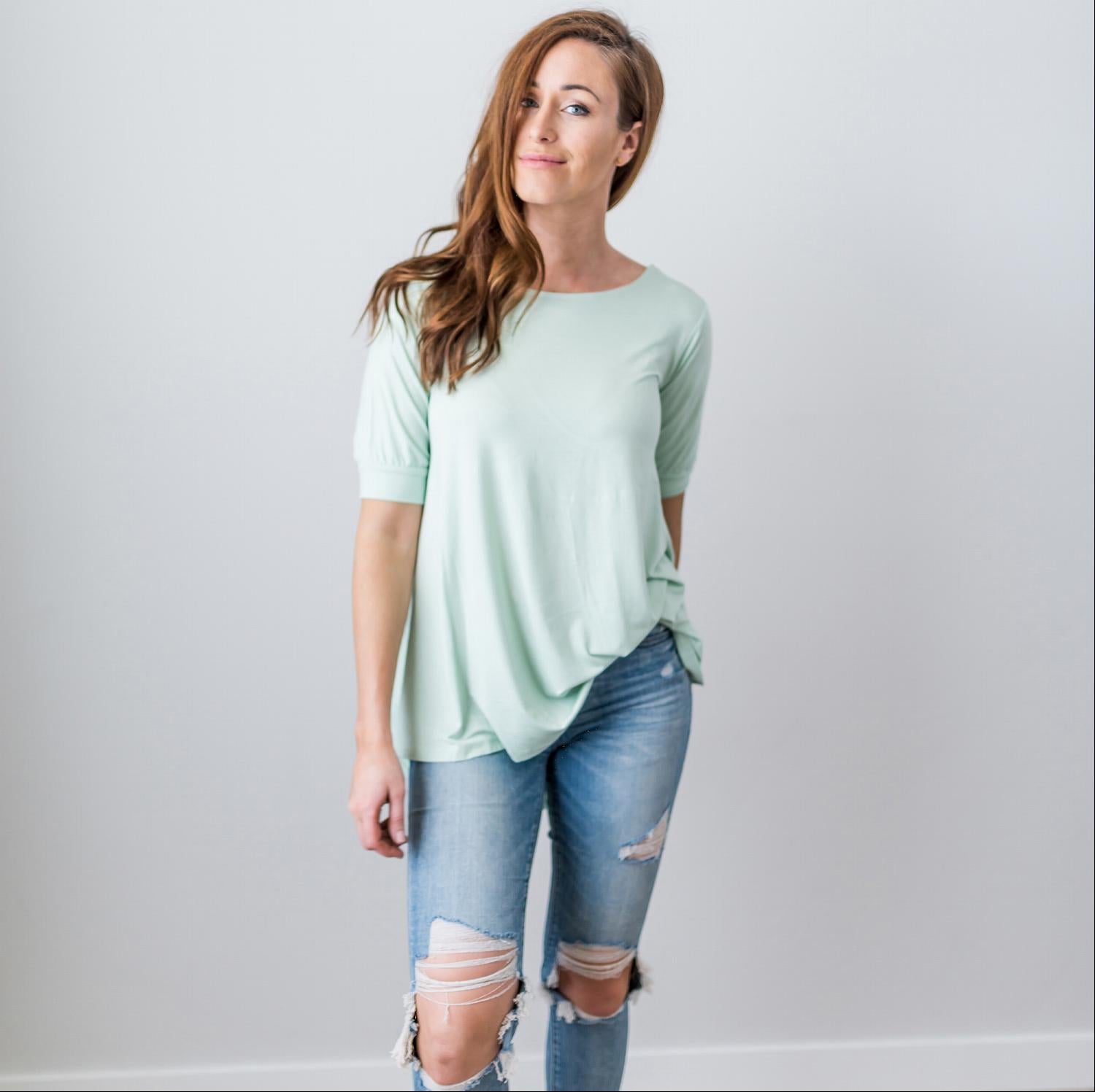 A stylish Criss Cross Back Hi-Low Scoop Hem Top in soft fabric, featuring three-quarter sleeves and a flattering fit, perfect for spring and summer wear.