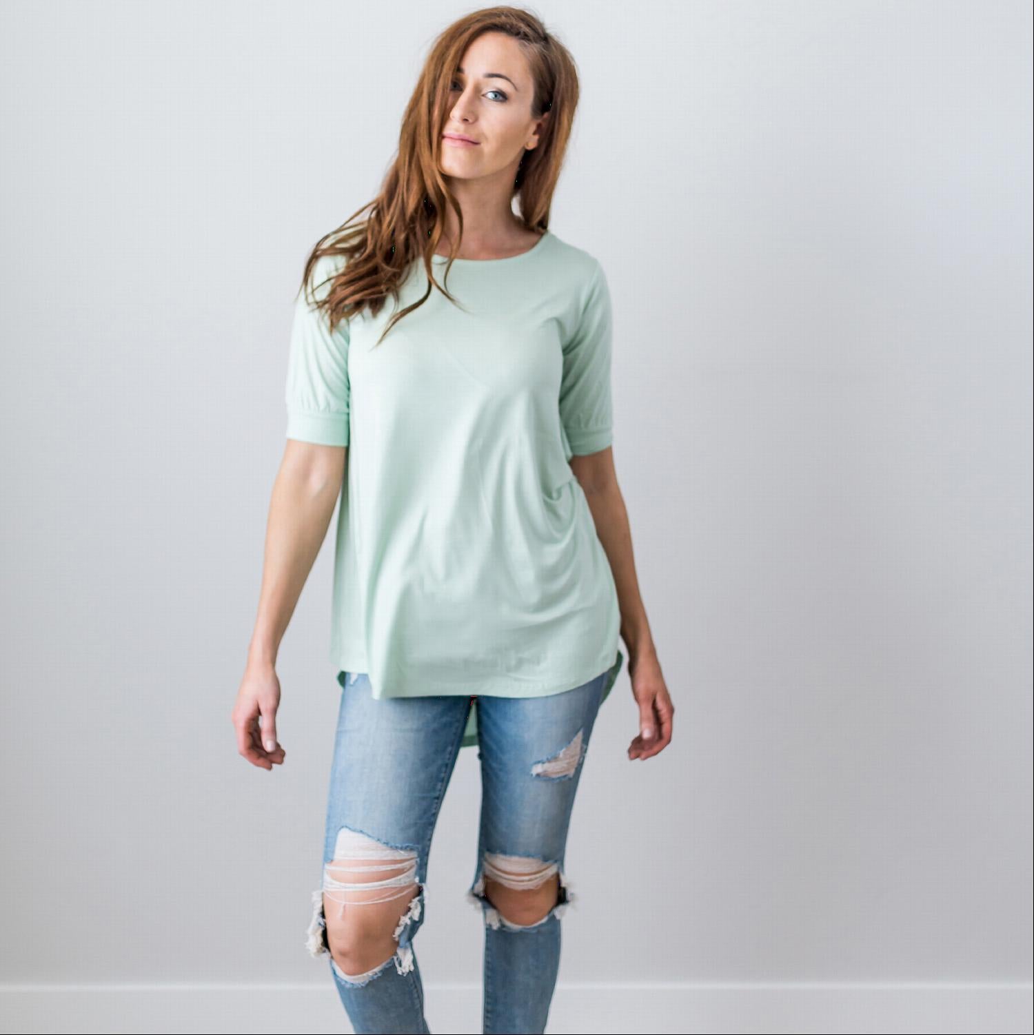 A stylish Criss Cross Back Hi-Low Scoop Hem Top in soft fabric, featuring three-quarter sleeves and a flattering fit, perfect for spring and summer wear.