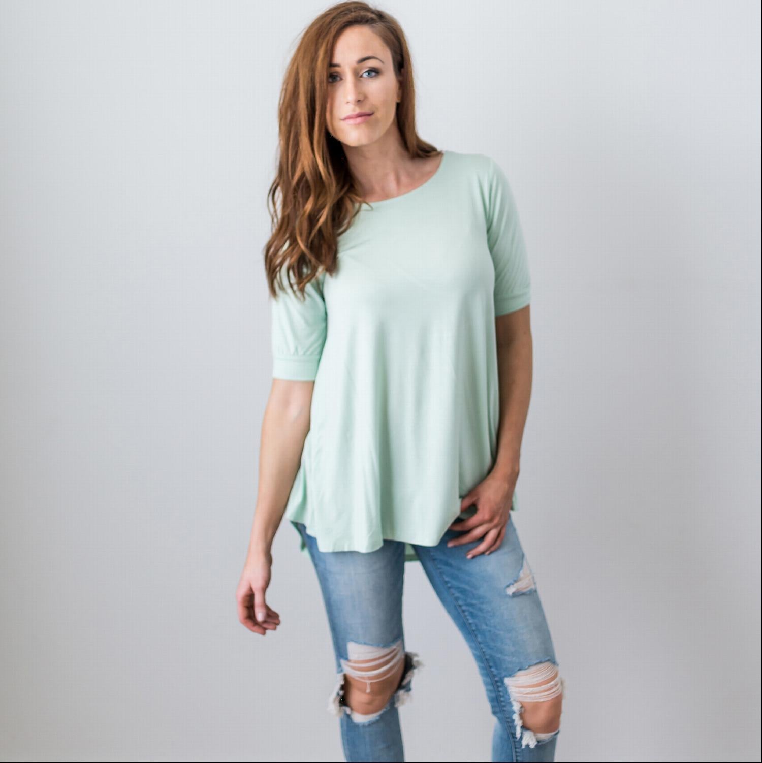 A stylish Criss Cross Back Hi-Low Scoop Hem Top in soft fabric, featuring three-quarter sleeves and a flattering fit, perfect for spring and summer wear.