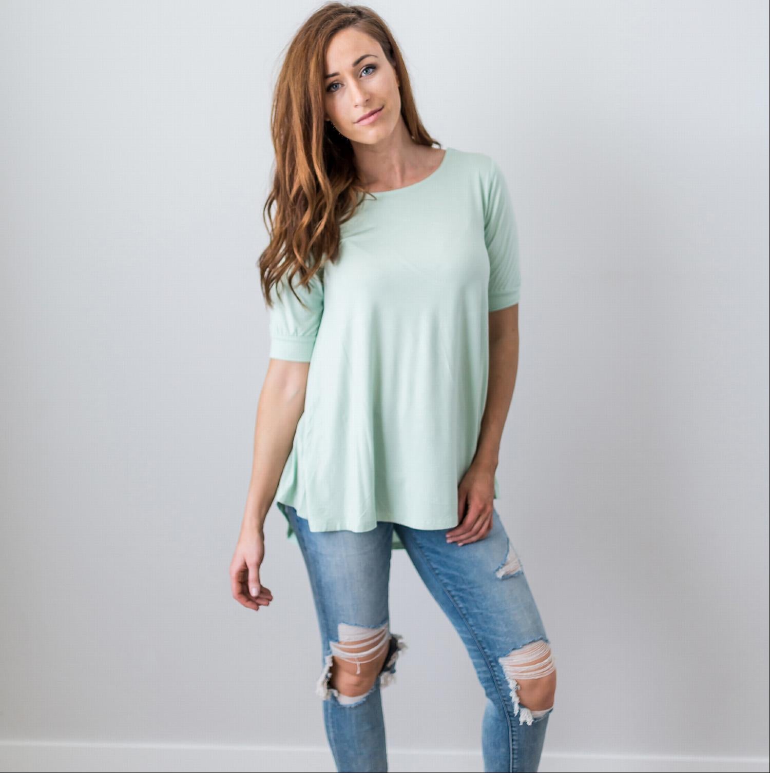 A stylish Criss Cross Back Hi-Low Scoop Hem Top in soft fabric, featuring three-quarter sleeves and a flattering fit, perfect for spring and summer wear.