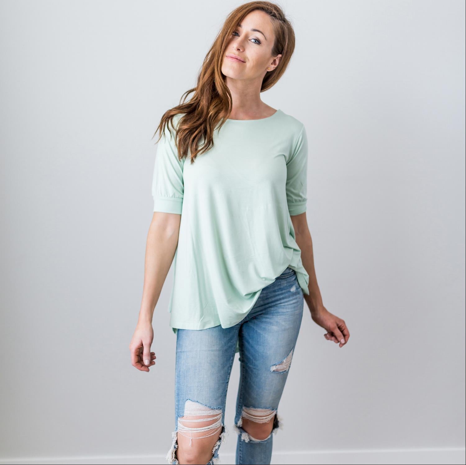 A stylish Criss Cross Back Hi-Low Scoop Hem Top in soft fabric, featuring three-quarter sleeves and a flattering fit, perfect for spring and summer wear.