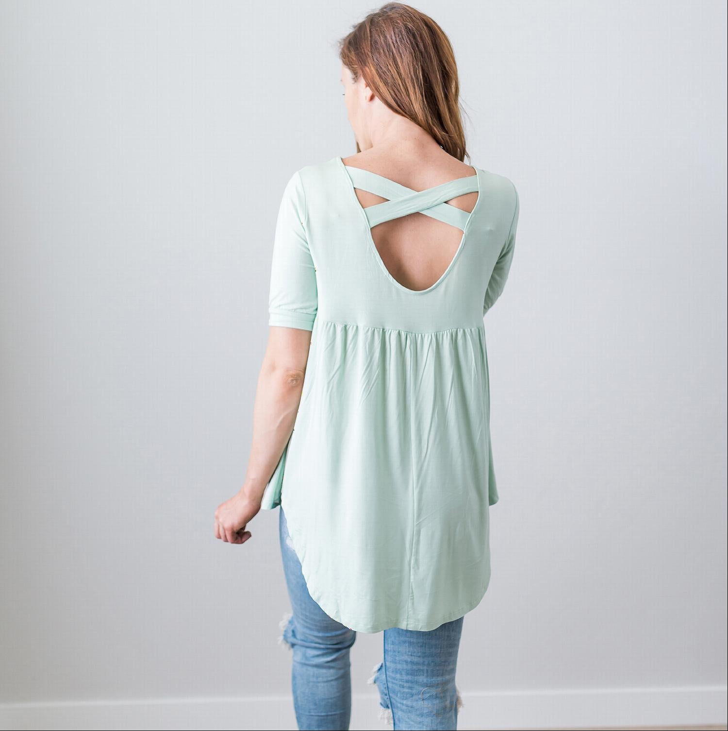 A stylish Criss Cross Back Hi-Low Scoop Hem Top in soft fabric, featuring three-quarter sleeves and a flattering fit, perfect for spring and summer wear.