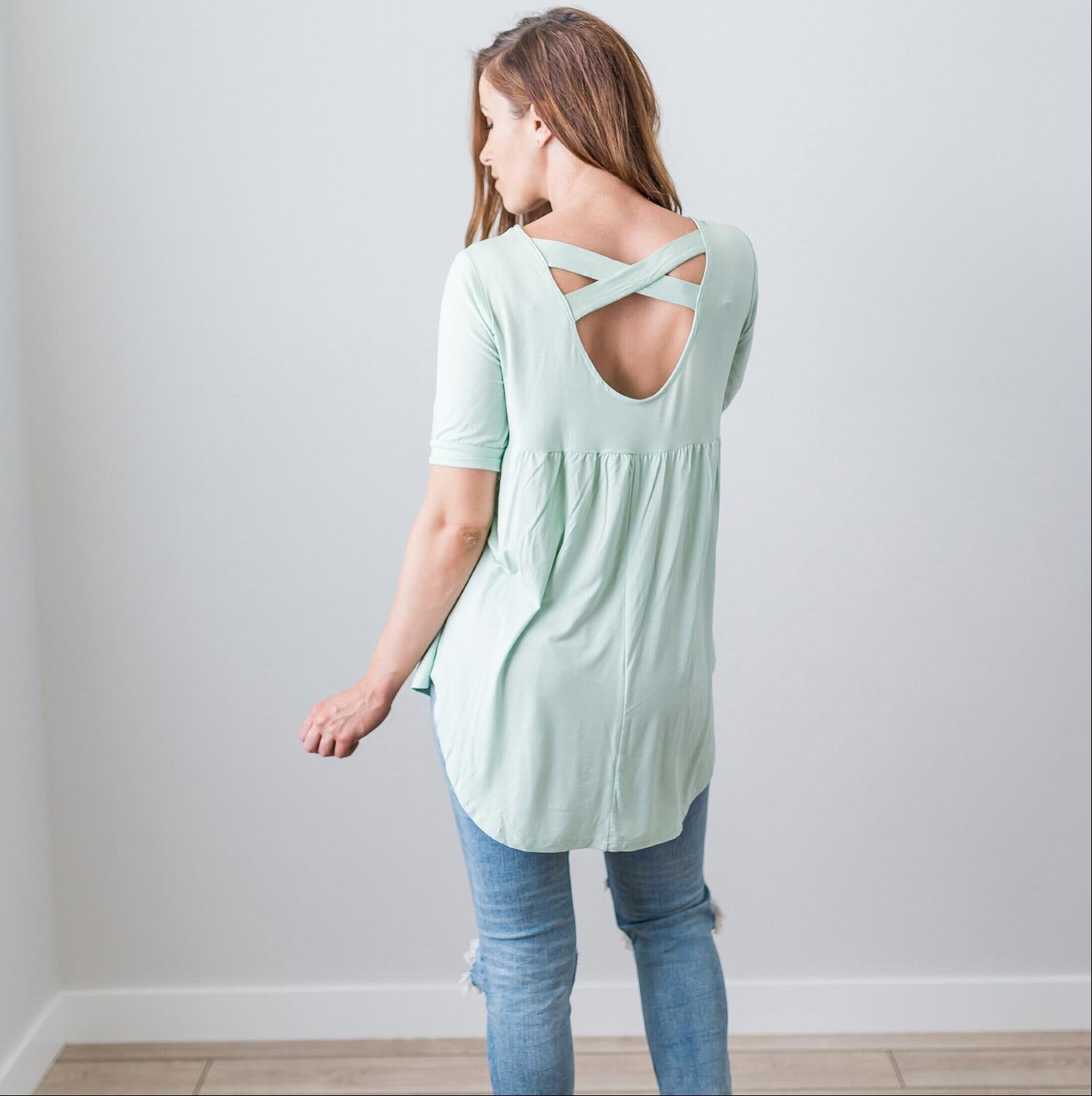 A stylish Criss Cross Back Hi-Low Scoop Hem Top in soft fabric, featuring three-quarter sleeves and a flattering fit, perfect for spring and summer wear.