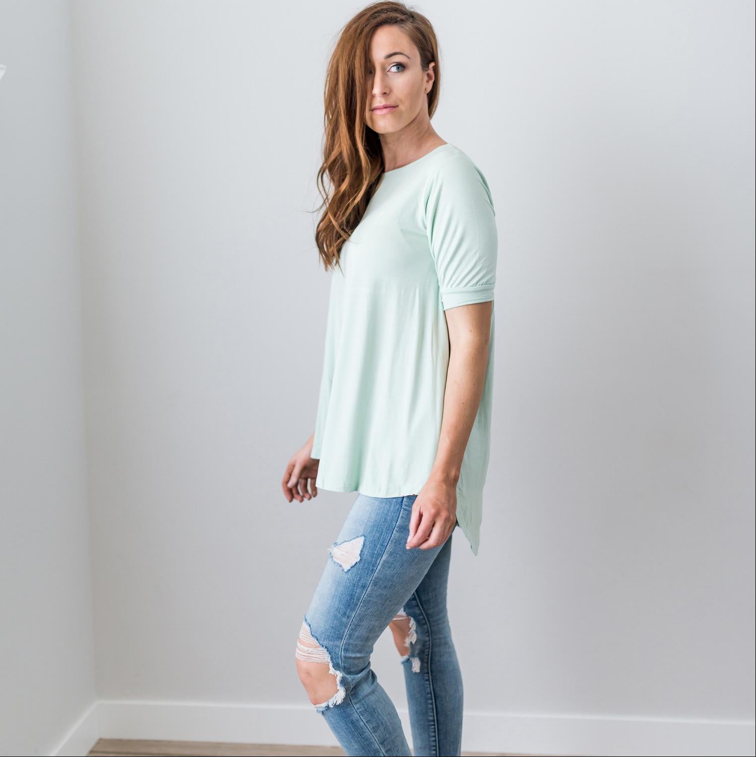 A stylish Criss Cross Back Hi-Low Scoop Hem Top in soft fabric, featuring three-quarter sleeves and a flattering fit, perfect for spring and summer wear.