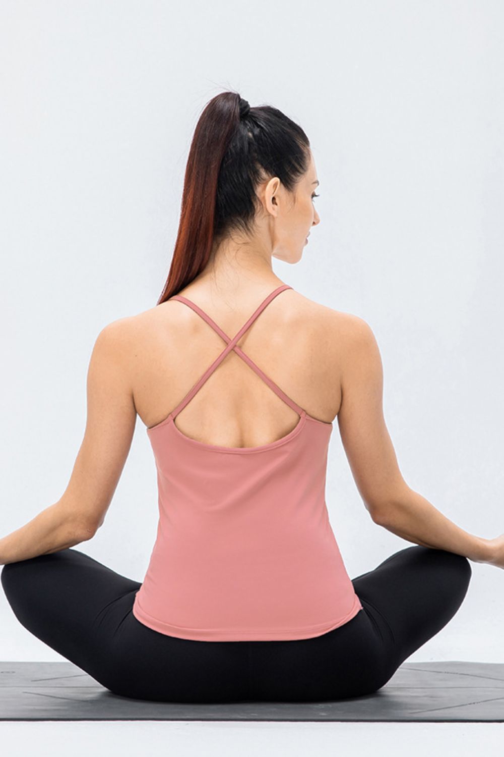 Crisscross Back Spaghetti Strap Yoga Cami in solid color, showcasing its stylish design and removable padding.