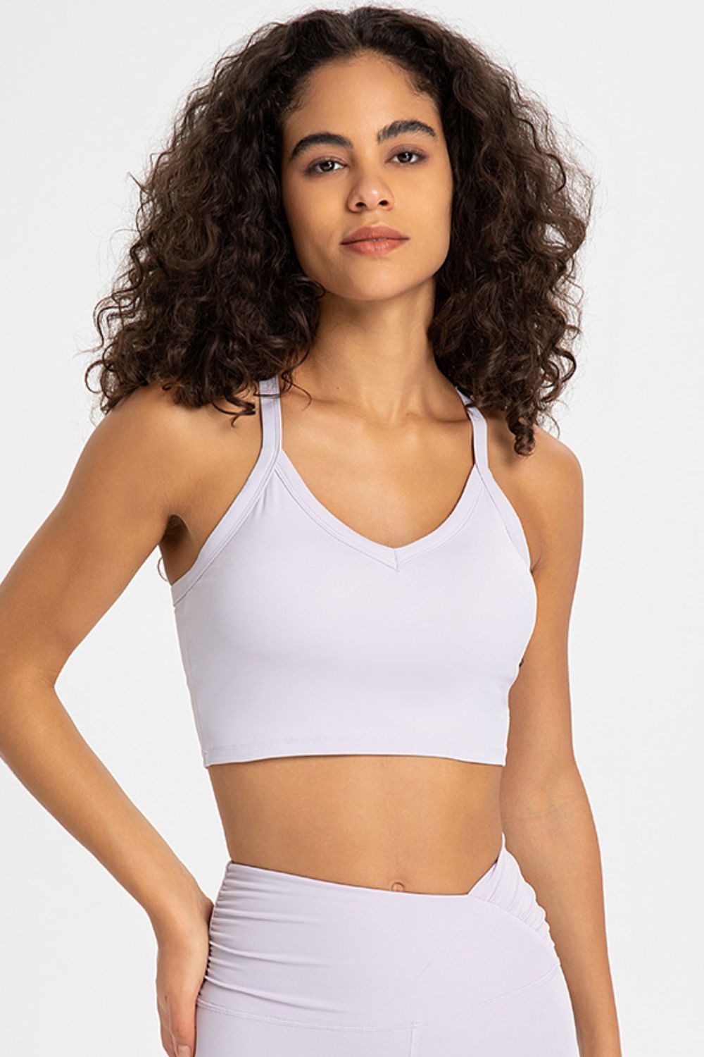 Crisscross Back V-Neck Sports Bra in solid color, showcasing its stylish design and comfortable fit, perfect for yoga and workouts.