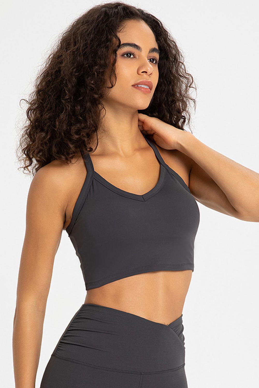 Crisscross Back V-Neck Sports Bra in solid color, showcasing its stylish design and comfortable fit, perfect for yoga and workouts.