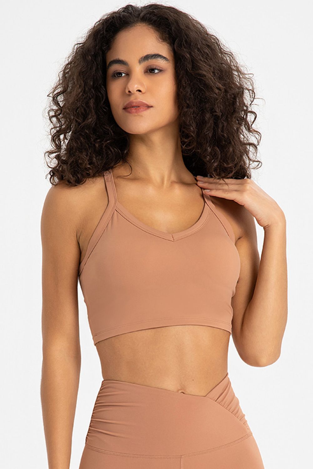 Crisscross Back V-Neck Sports Bra in solid color, showcasing its stylish design and comfortable fit, perfect for yoga and workouts.