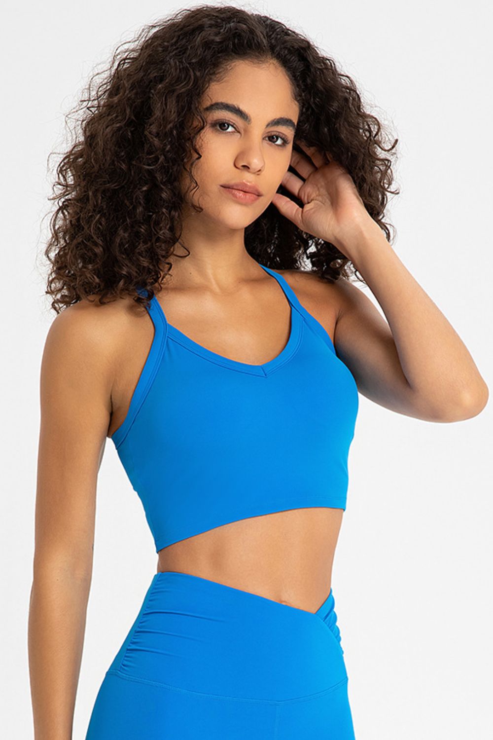 Crisscross Back V-Neck Sports Bra in solid color, showcasing its stylish design and comfortable fit, perfect for yoga and workouts.