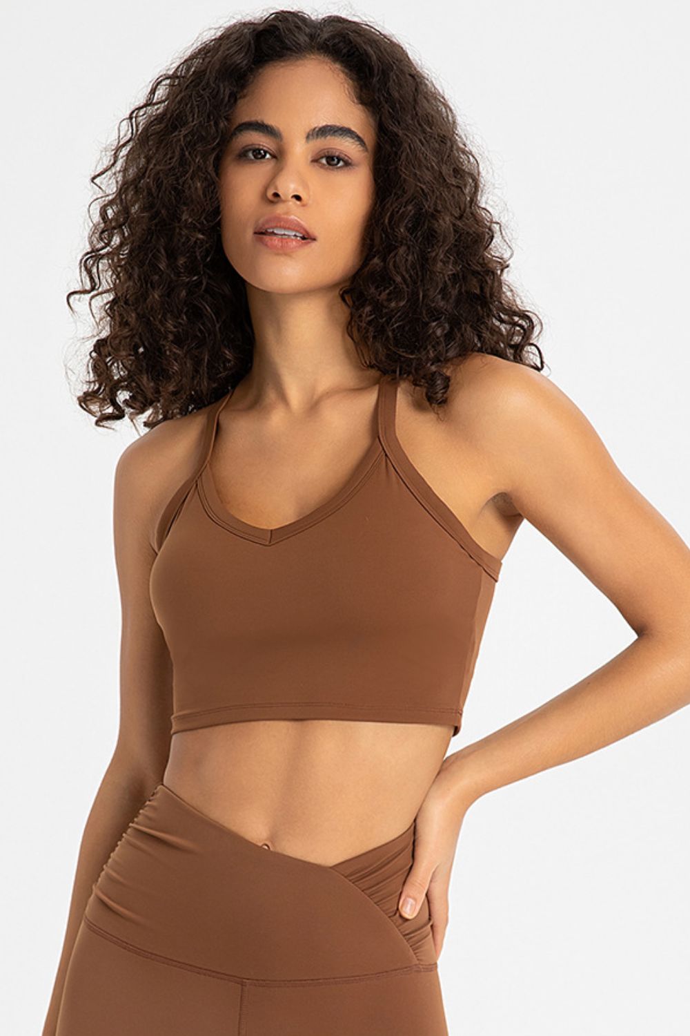 Crisscross Back V-Neck Sports Bra in solid color, showcasing its stylish design and comfortable fit, perfect for yoga and workouts.