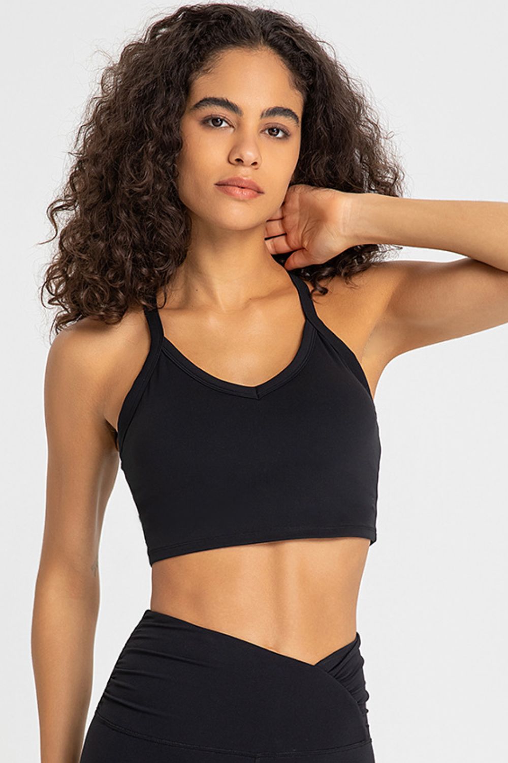 Crisscross Back V-Neck Sports Bra in solid color, showcasing its stylish design and comfortable fit, perfect for yoga and workouts.