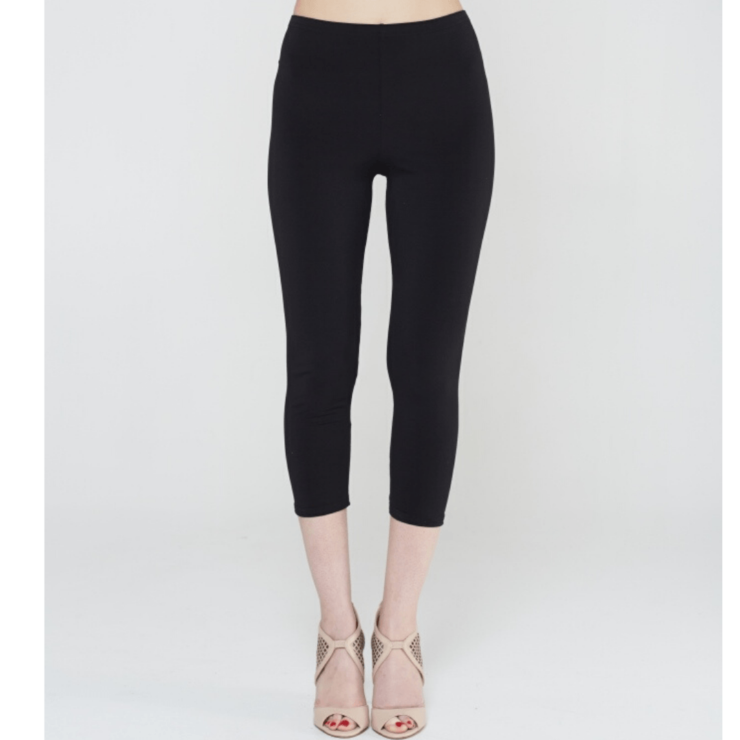 A pair of stylish black crop tights with an elastic waistband, showcasing their comfortable fit and stretchy fabric.