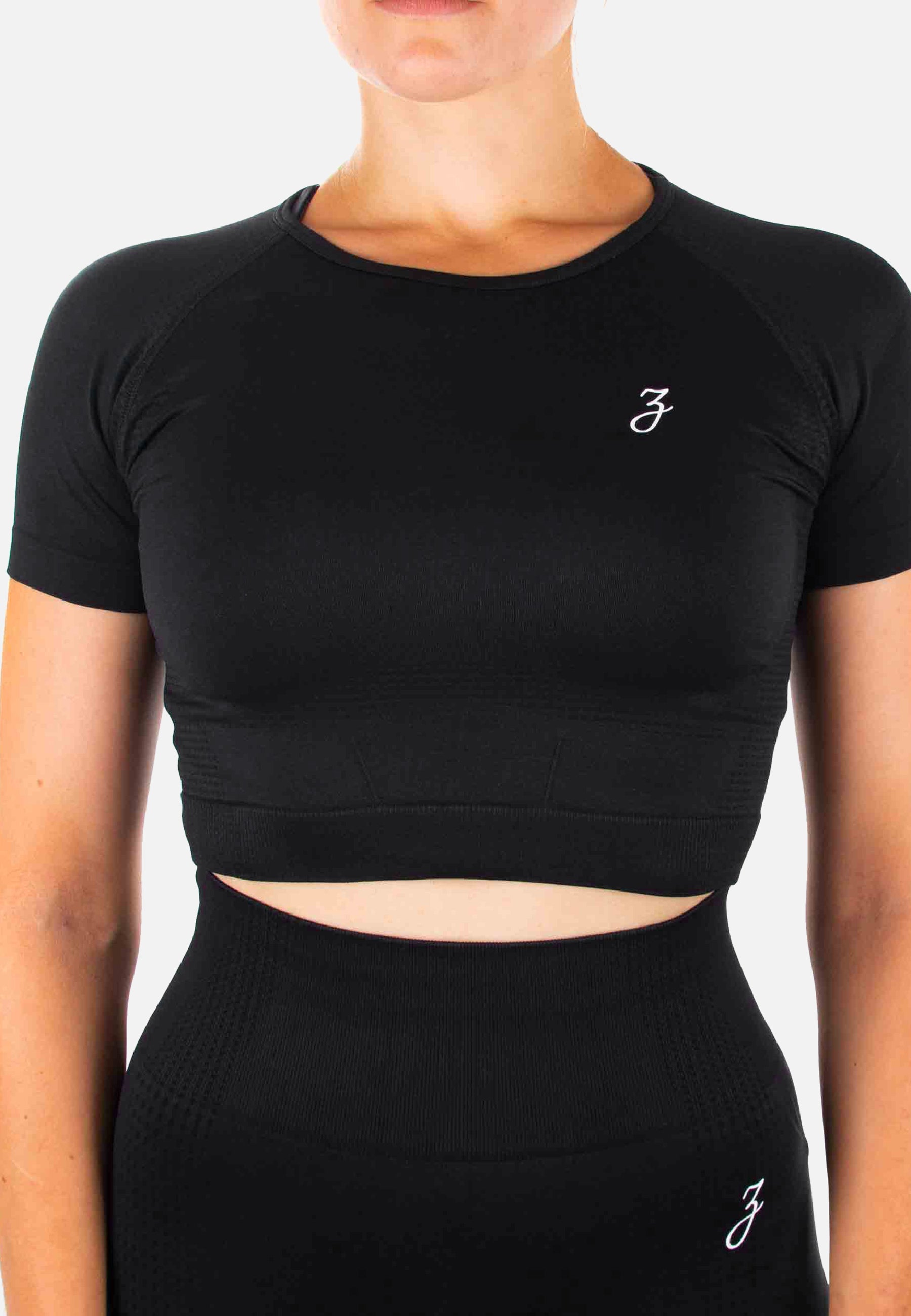 Schwarzes Crop Top Dynamic für Damen, figurbetont mit kurzen Ärmeln, ideal für Sport und Freizeit.