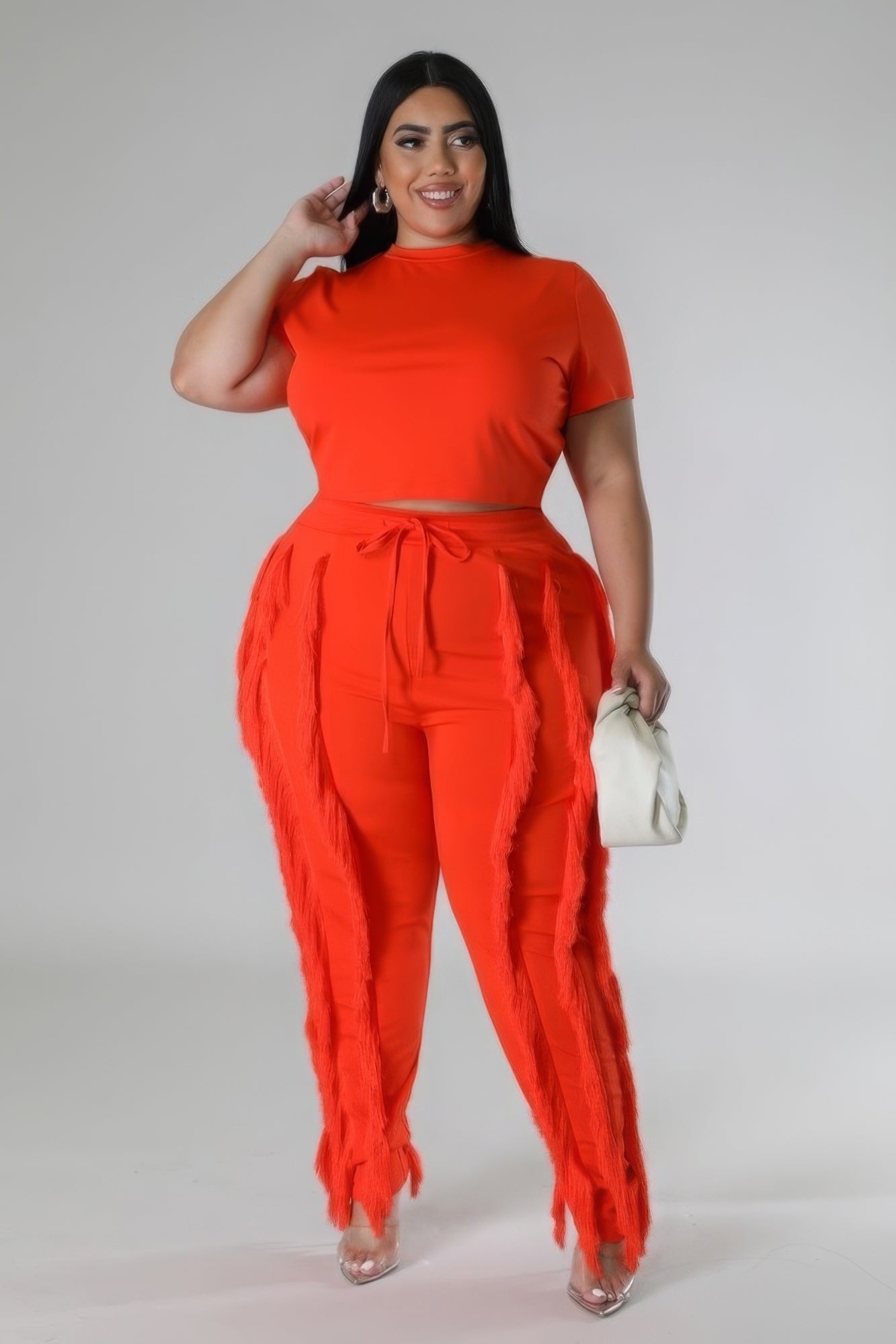 A vibrant orange crop top two-piece set featuring a round neck crop top and high-waisted pants, perfect for summer outings.