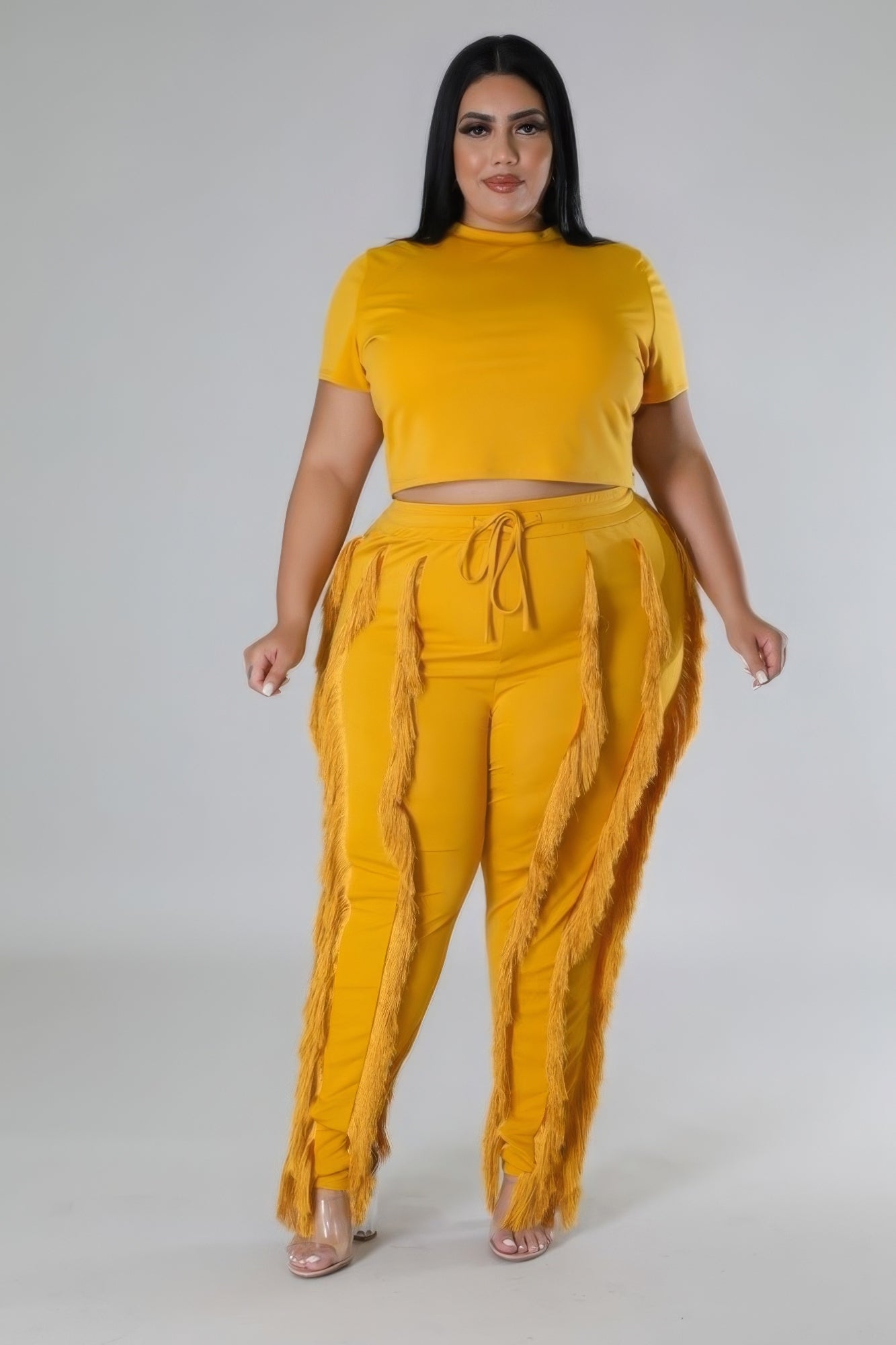 A vibrant orange crop top two-piece set featuring a round neck crop top and high-waisted pants, perfect for summer outings.