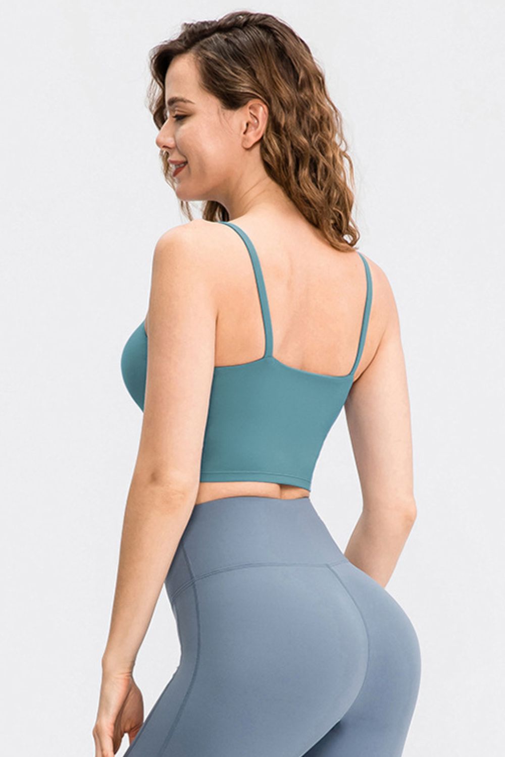 Cropped Yoga Tank Top in solid color with spaghetti straps and removable padding, showcasing its stylish scoop neck design.