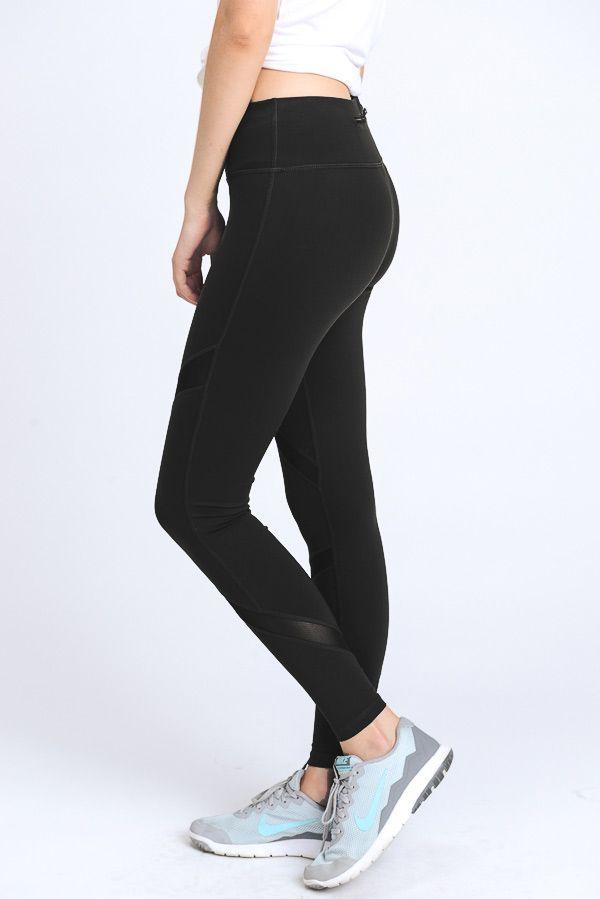 A pair of stylish black cross mesh leggings featuring slanted mesh panels and a zipper pocket on the back.