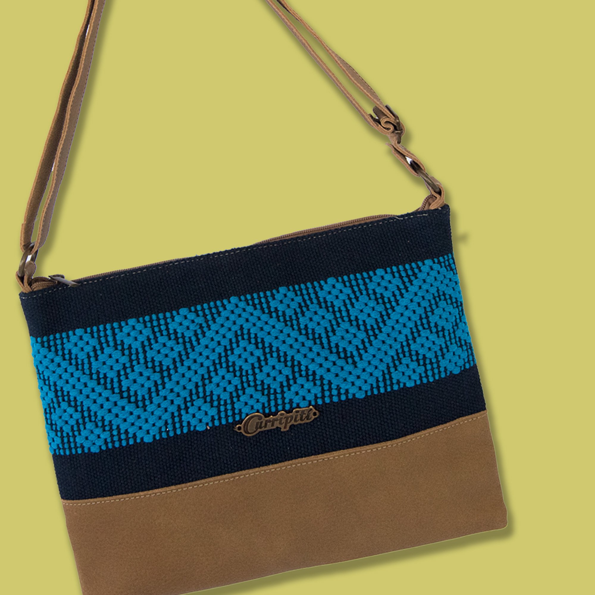 Stylish camel leather cross-body bag with blue stripe, featuring a zipper closure and adjustable strap.