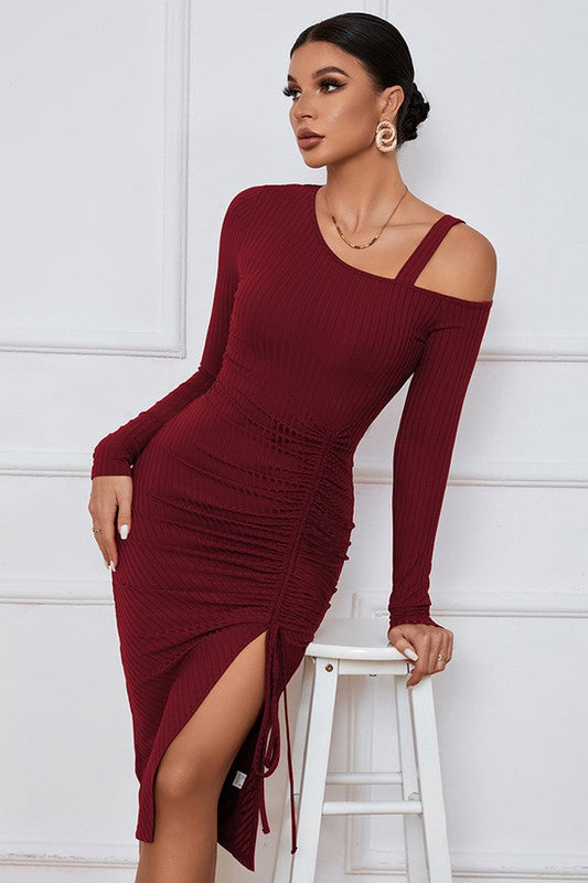 A stylish burgundy cut off dress featuring a one-shoulder design, long sleeves, and a sexy cut-off side detail, perfect for evening wear.