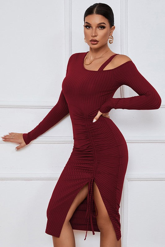 A stylish burgundy cut off dress featuring a one-shoulder design, long sleeves, and a sexy cut-off side detail, perfect for evening wear.