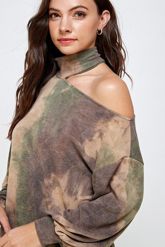 A stylish CUT OUT TIE DYE TOP featuring a vibrant tie-dye pattern, cut-out shoulder design, mock neck, and balloon sleeves.