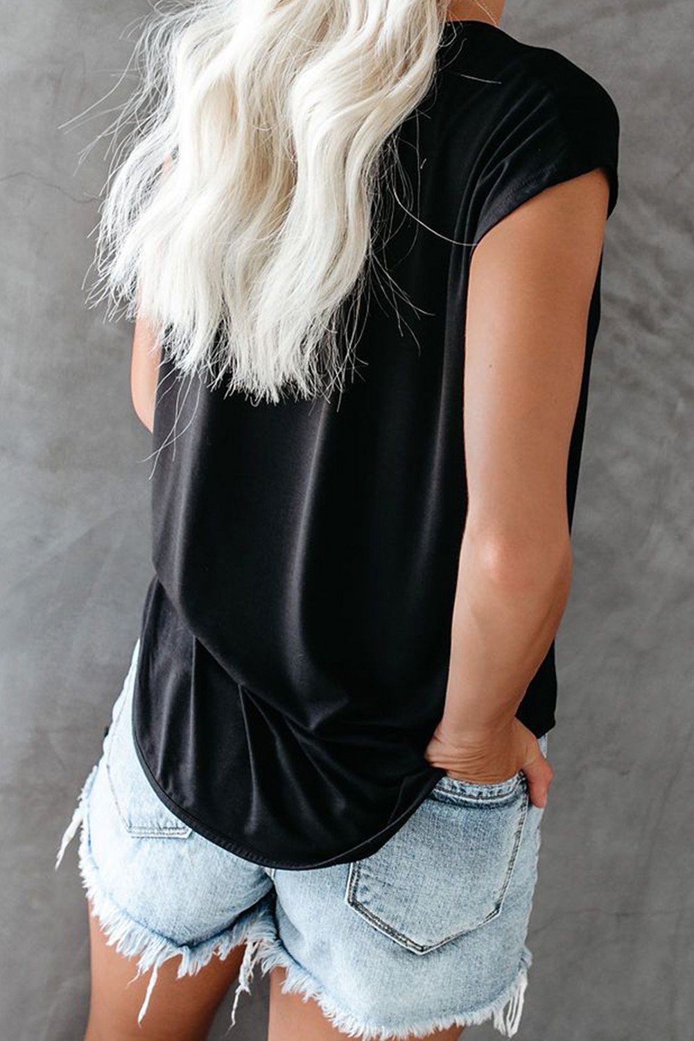 A stylish Cut Out T-shirt featuring a round neck, short sleeves, and unique cut-out details, made from soft cotton knit fabric.