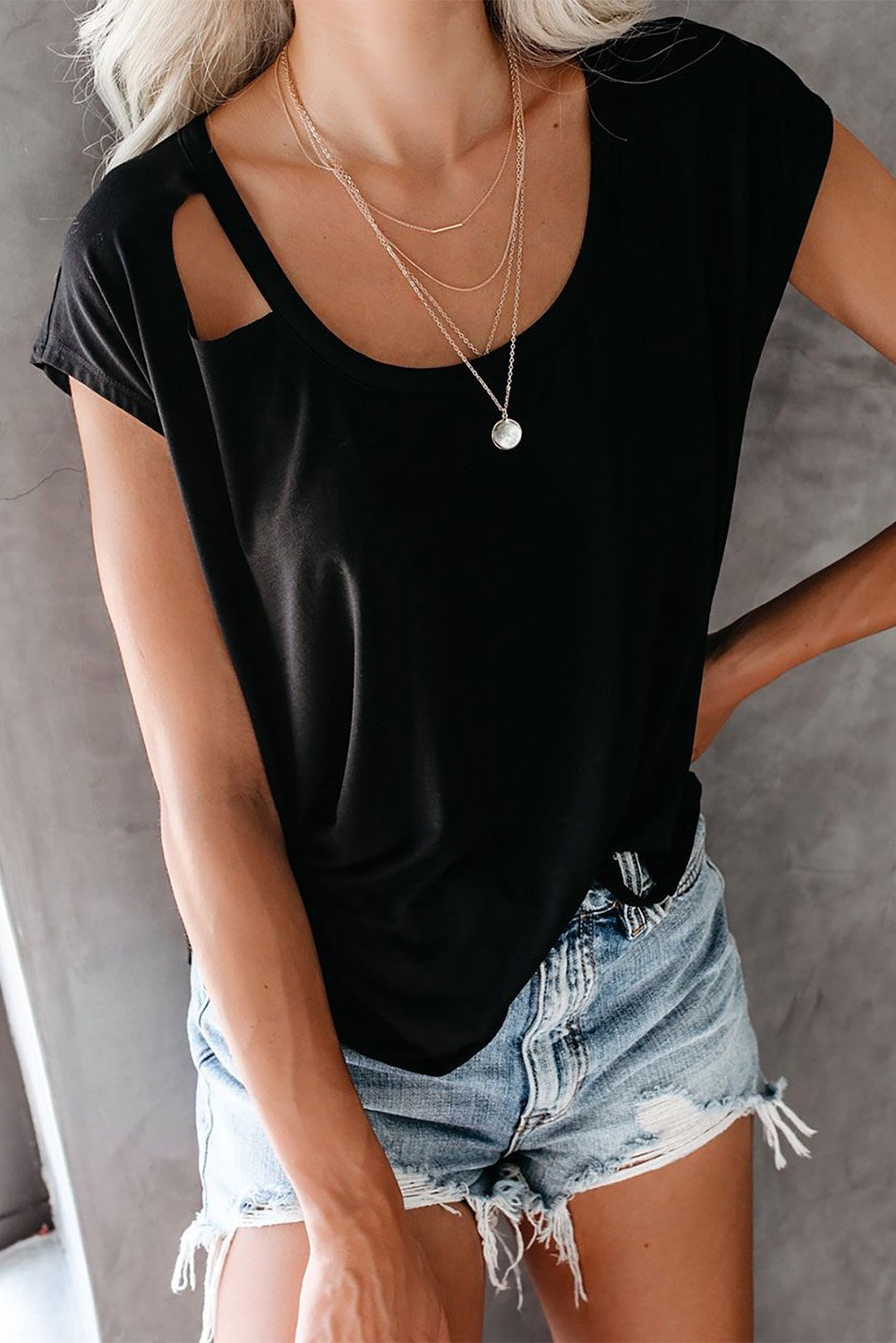 A stylish Cut Out T-shirt featuring a round neck, short sleeves, and unique cut-out details, made from soft cotton knit fabric.