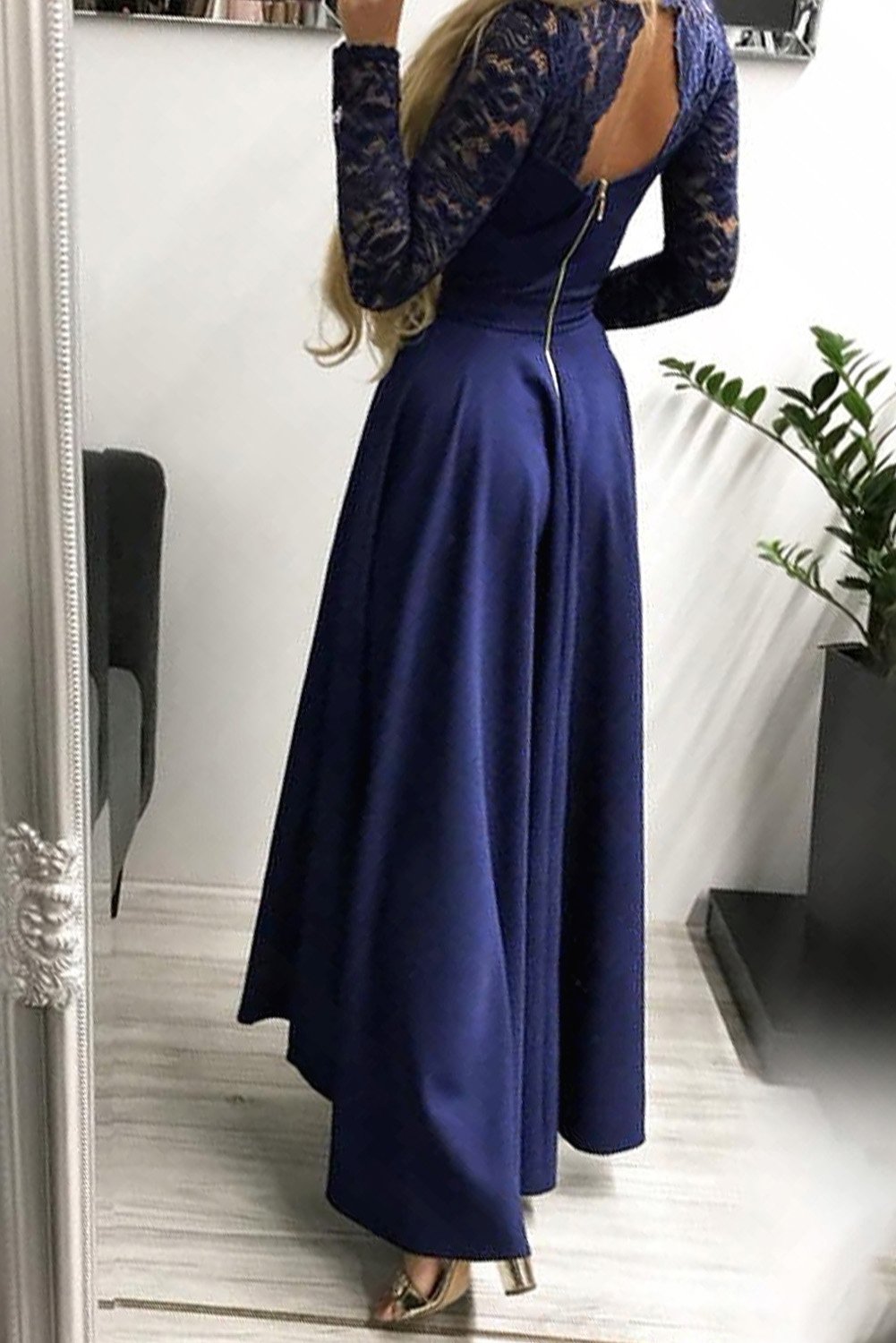 Dark blue evening dress featuring a V-neck, lace back, and high-low hem, perfect for formal occasions.