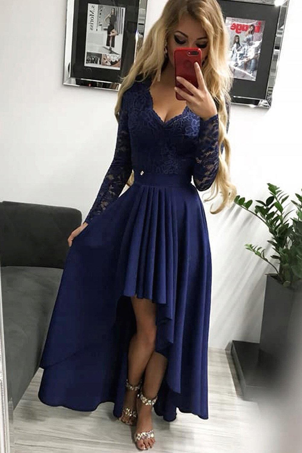 Dark blue evening dress featuring a V-neck, lace back, and high-low hem, perfect for formal occasions.