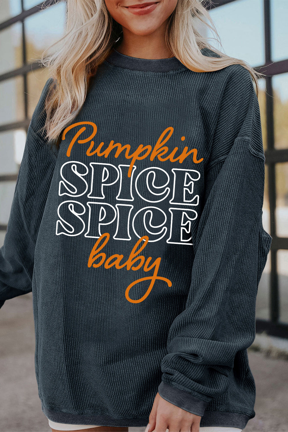 Dark grey textured sweatshirt featuring a playful pumpkin spice baby graphic, perfect for Halloween.