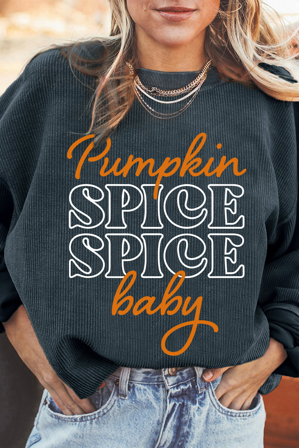 Dark grey textured sweatshirt featuring a playful pumpkin spice baby graphic, perfect for Halloween.