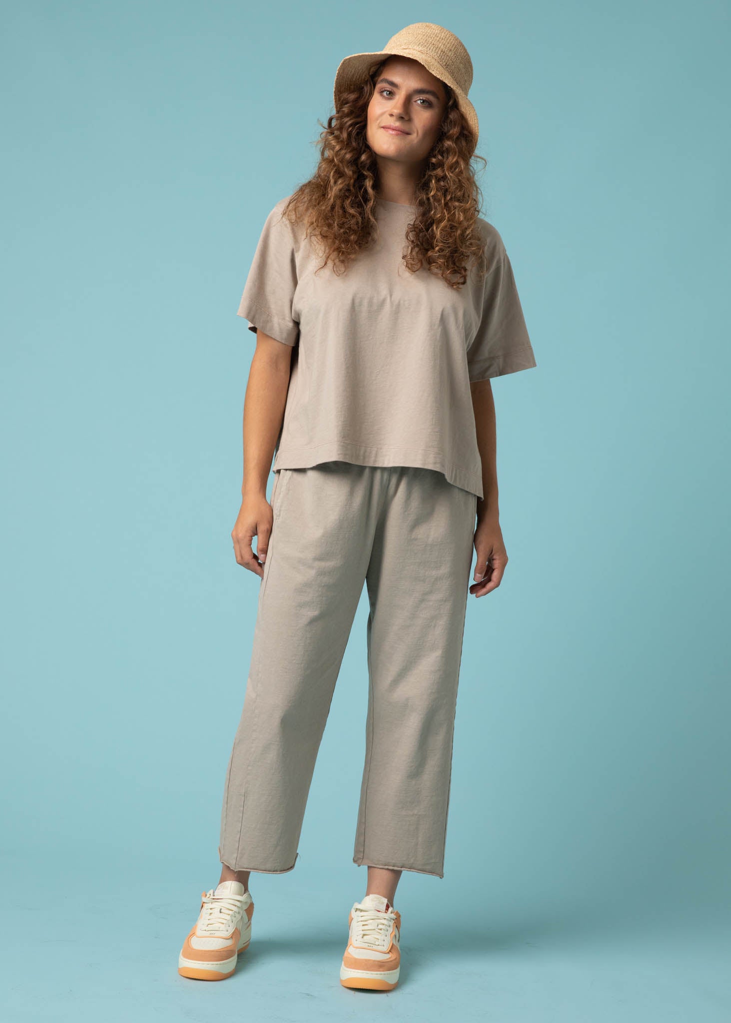 Daybreak Pant in Pebble showcasing a modern cropped length and relaxed fit, made from organic cotton jersey with side pockets.