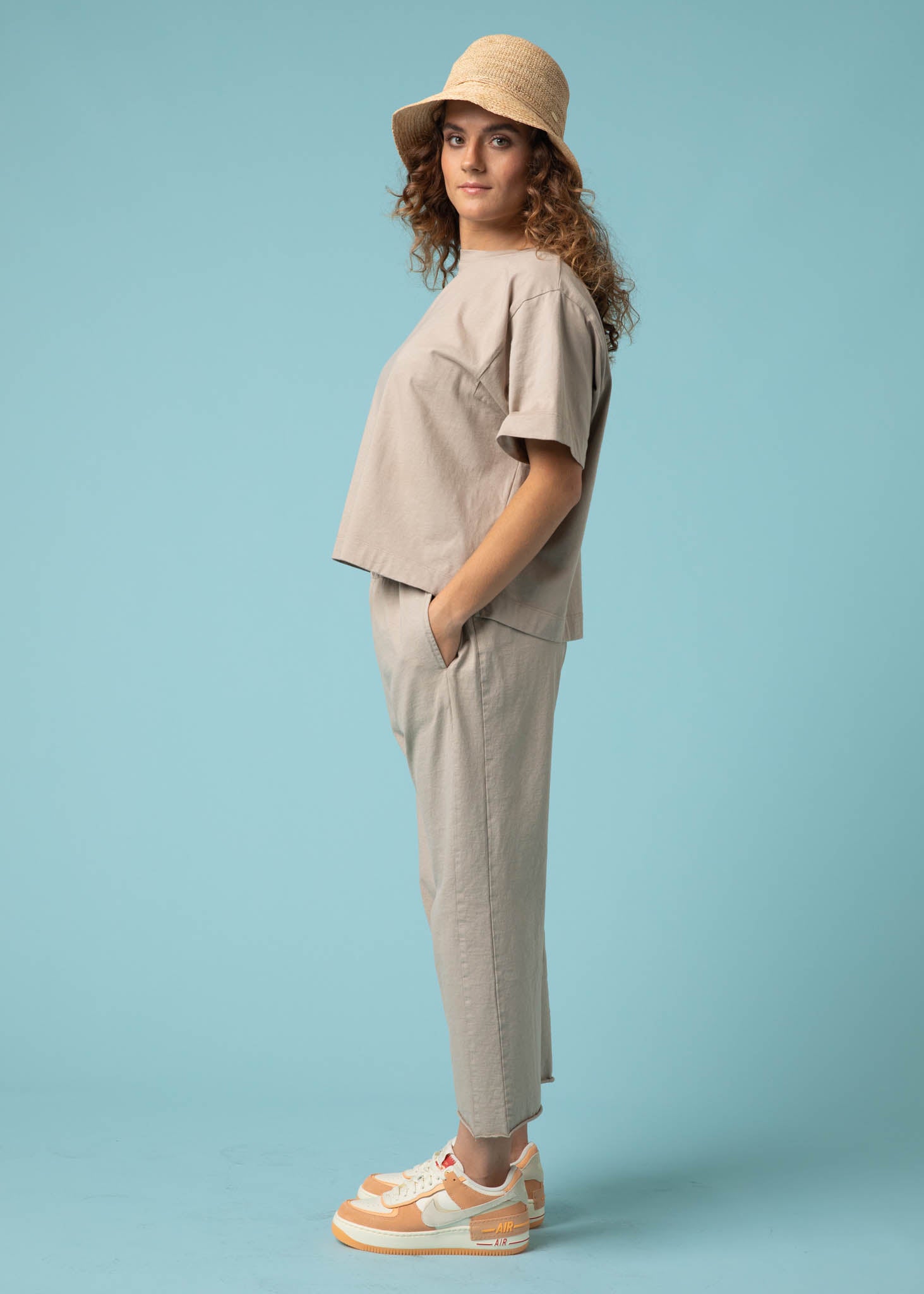 Daybreak Pant in Pebble showcasing a modern cropped length and relaxed fit, made from organic cotton jersey with side pockets.