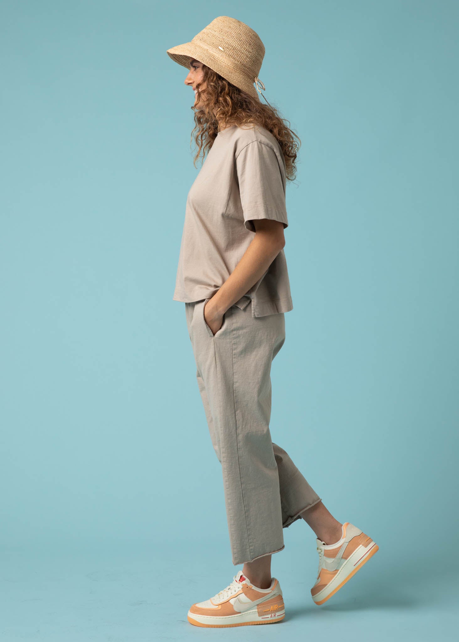 Daybreak Pant in Pebble showcasing a modern cropped length and relaxed fit, made from organic cotton jersey with side pockets.