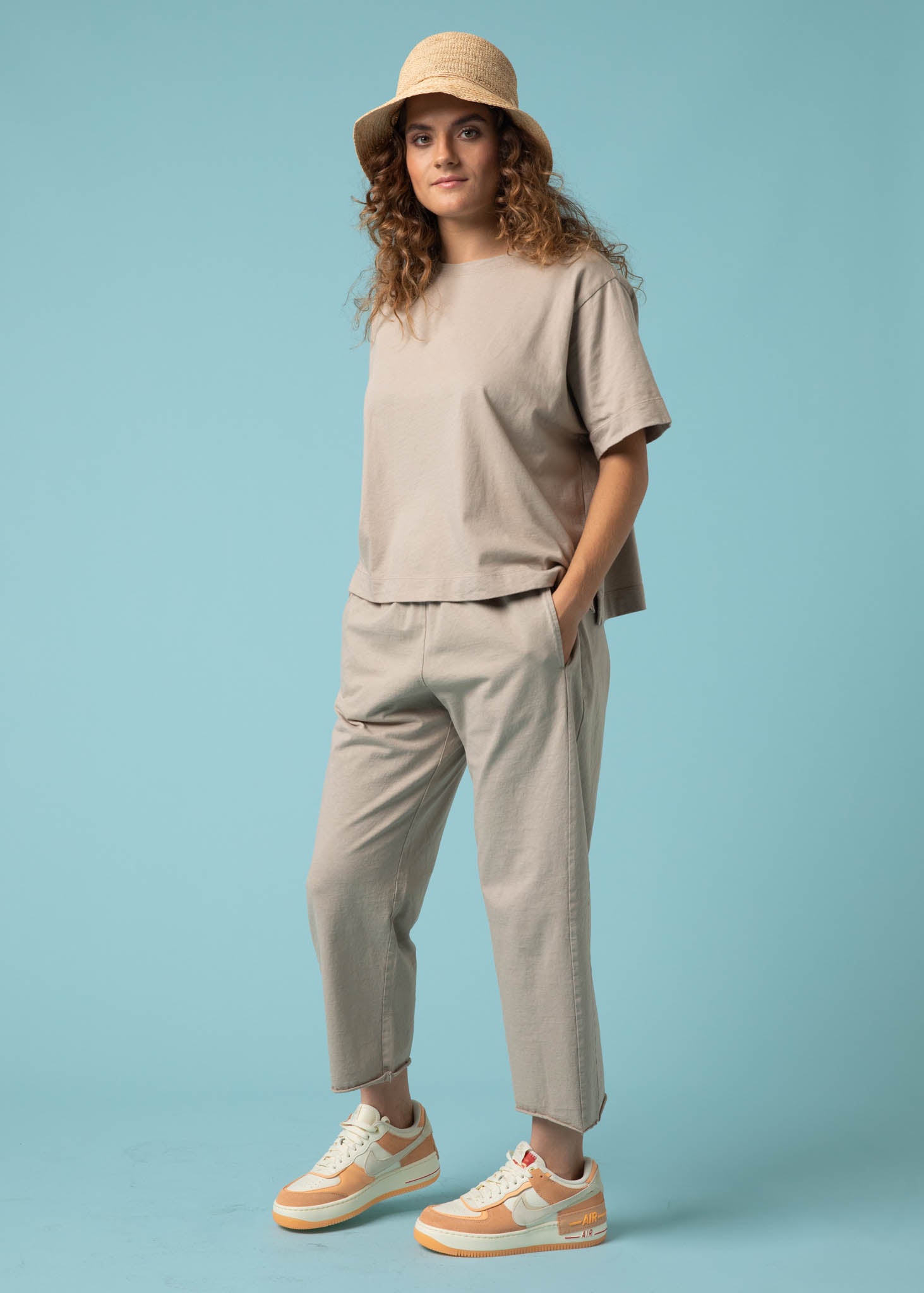 Daybreak Pant in Pebble showcasing a modern cropped length and relaxed fit, made from organic cotton jersey with side pockets.