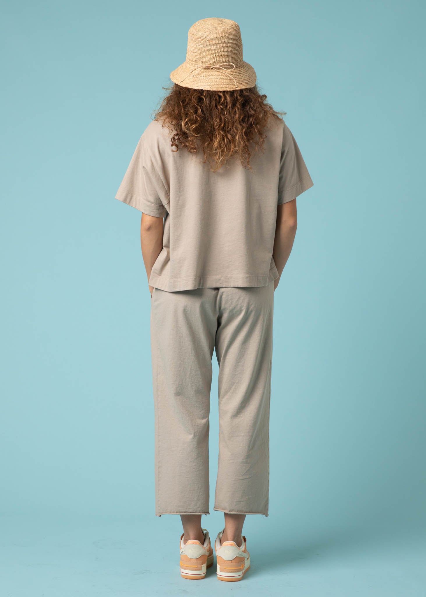 Daybreak Pant in Pebble showcasing a modern cropped length and relaxed fit, made from organic cotton jersey with side pockets.