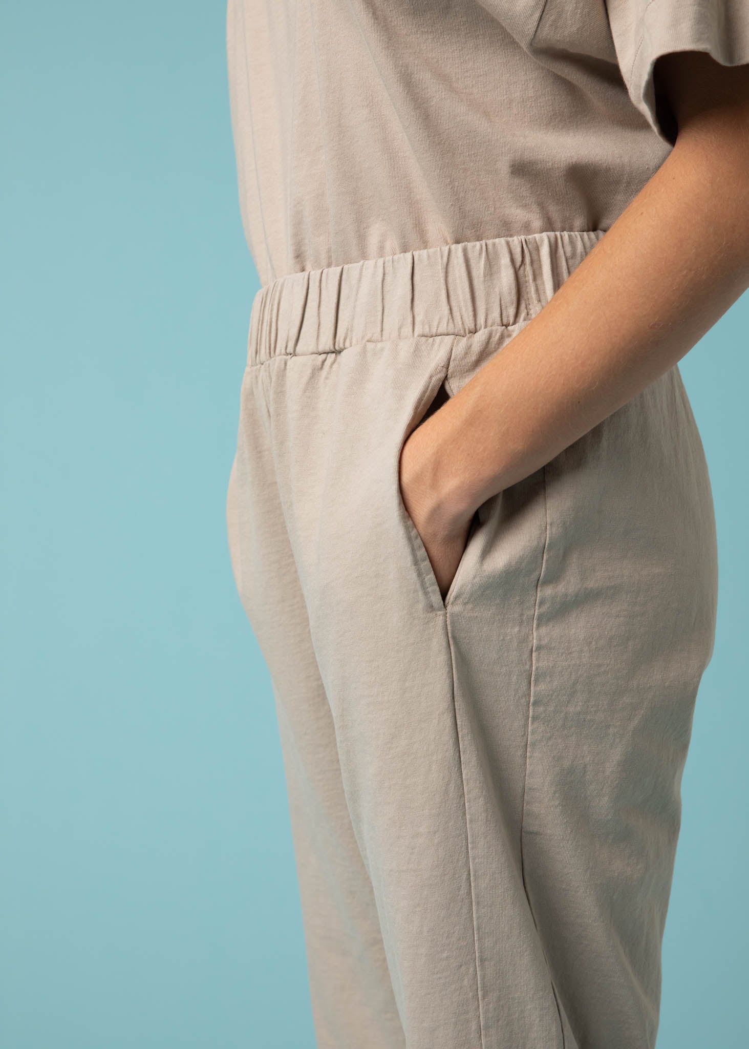 Daybreak Pant in Pebble showcasing a modern cropped length and relaxed fit, made from organic cotton jersey with side pockets.