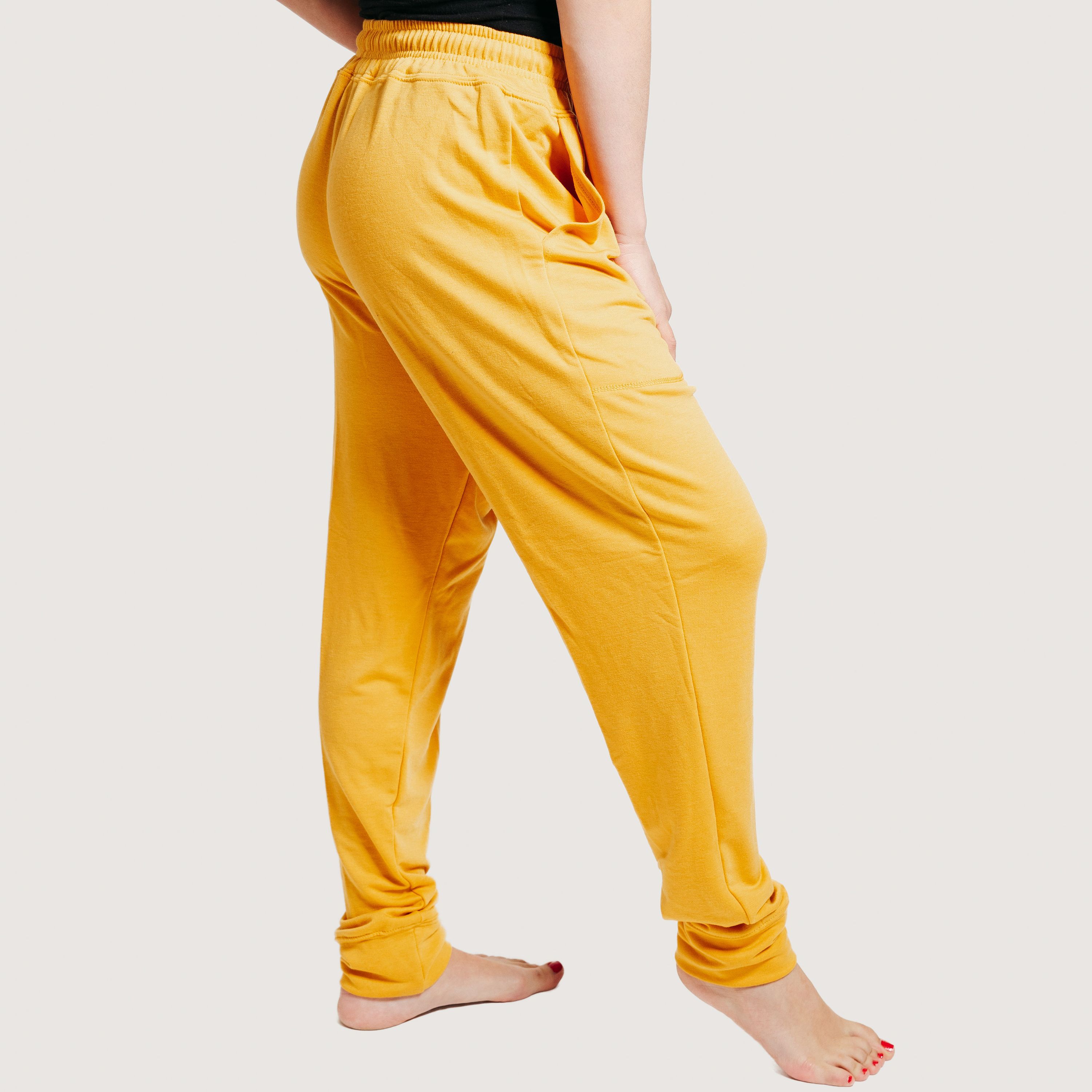 A pair of mustard yellow deep pocket joggers with a drawstring waistband, showcasing their soft fabric and stylish design.